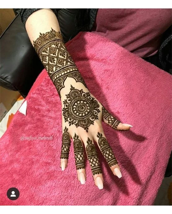 Whimsical Petal With Peacock Along Back Hand Mehndi Design